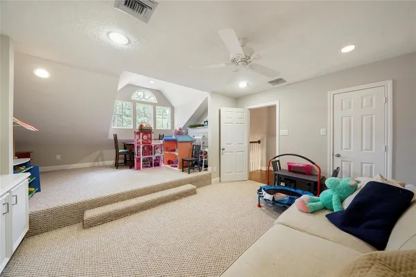 a bedroom with furniture and a large window