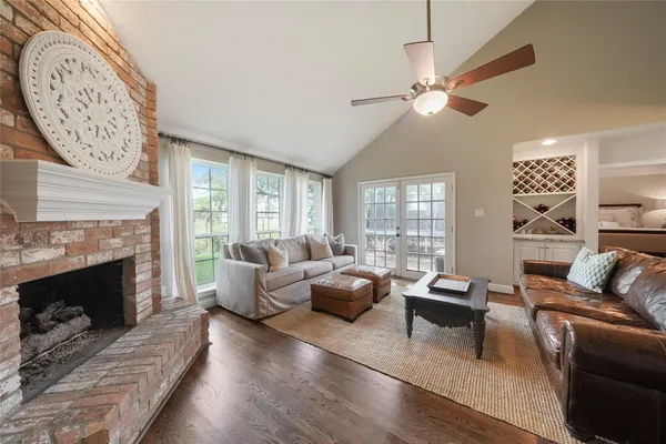 a living room with furniture a fireplace and a large window