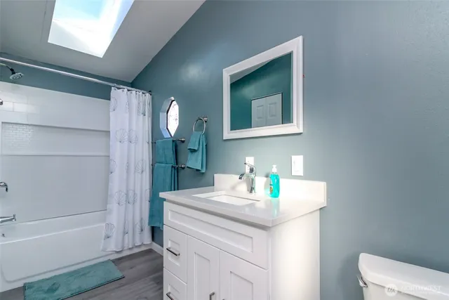 a bathroom with a toilet a sink and a window