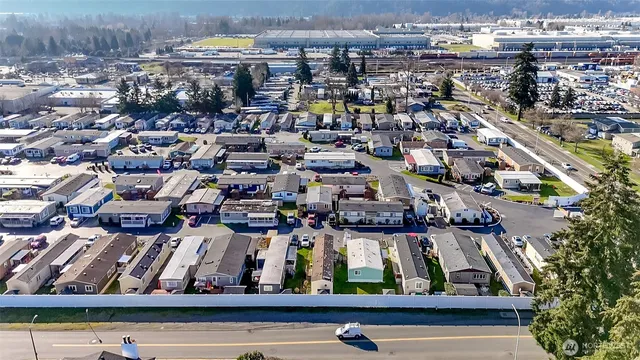an aerial view of a house with garden space and street view
