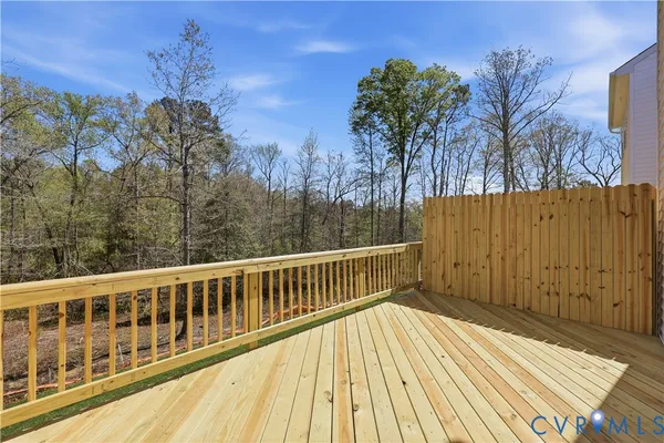 a view of balcony with wooden floor and fence