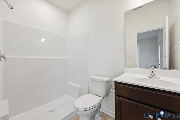 a bathroom with a sink a toilet a vanity and mirror