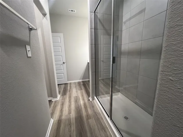 a bathroom with a glass door shower