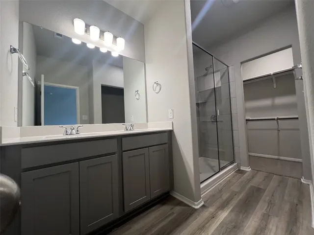 a bathroom with a double vanity sink and a mirror