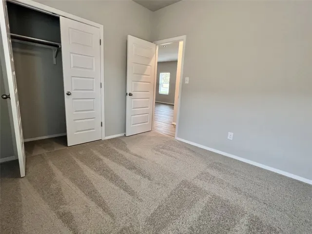 an empty room with closet area