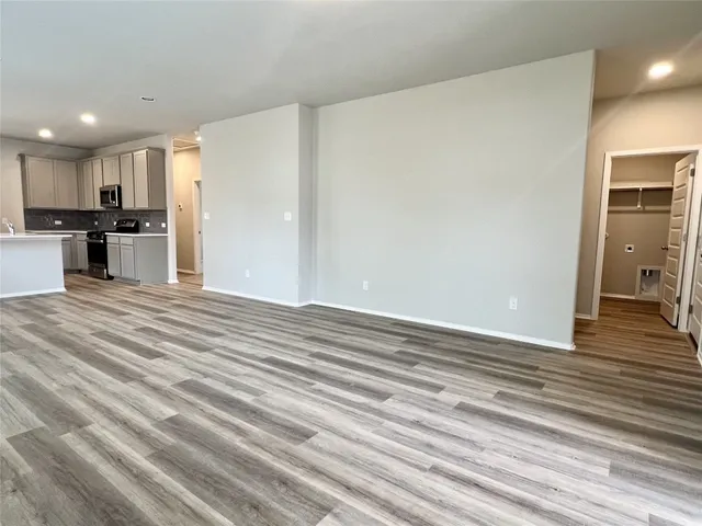 a view of a kitchen with kitchen island and stainless steel appliances