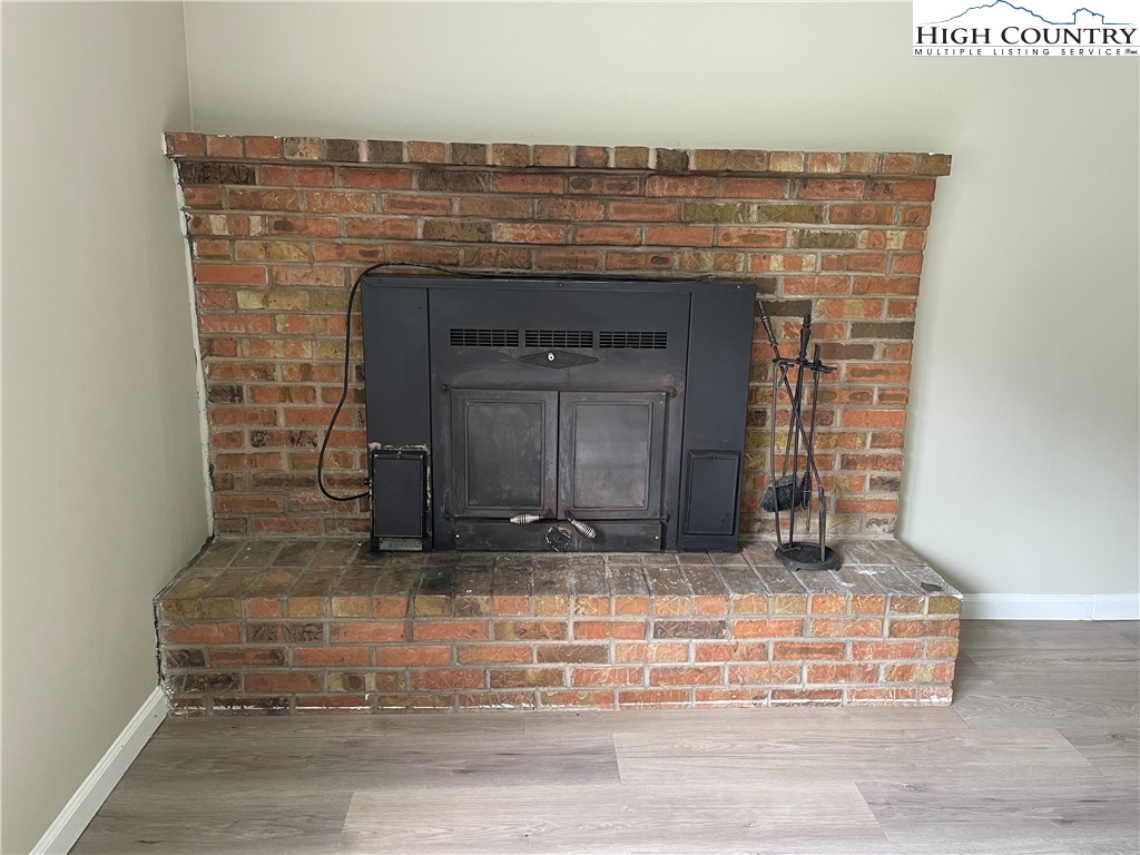 274 Bryan Davis Road Creston, NC 28615 - Photo 13 of 29 a fireplace with a clock on top