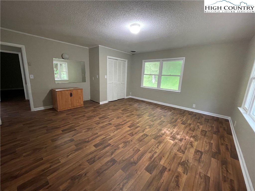 274 Bryan Davis Road Creston, NC 28615 - Photo 17 of 29 an empty room with wooden floor and windows