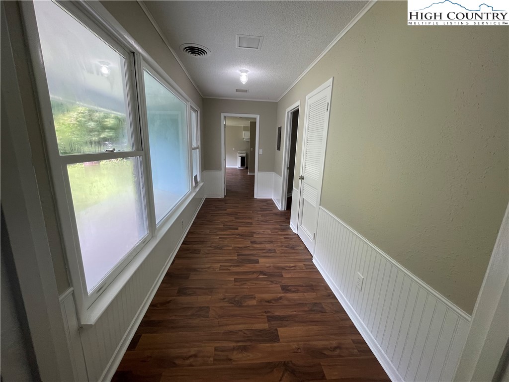 274 Bryan Davis Road Creston, NC 28615 - Photo 28 of 29 a view of a hallway with wooden floor and windows