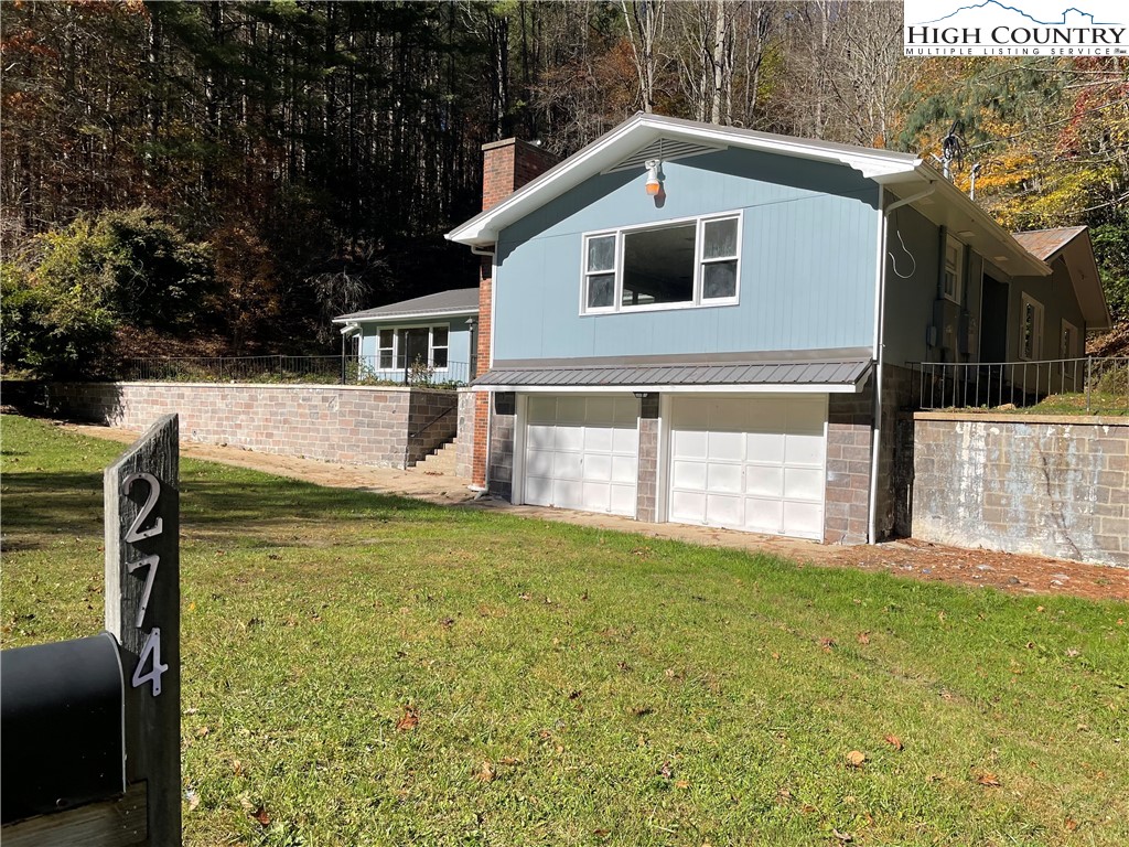 274 Bryan Davis Road Creston, NC 28615 - Photo 4 of 29 a front view of a house with garden