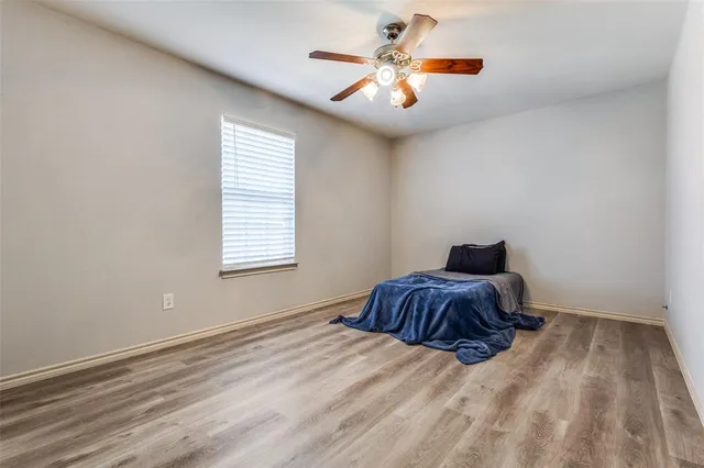 a spacious bedroom with a bed and a chandelier
