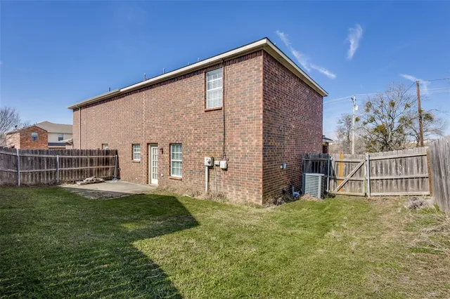 a backyard of a house with table and chairs