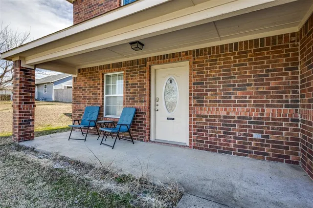 a view of a patio with table and chairs and wooden floor