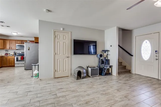 a view of a livingroom with furniture and a flat screen tv