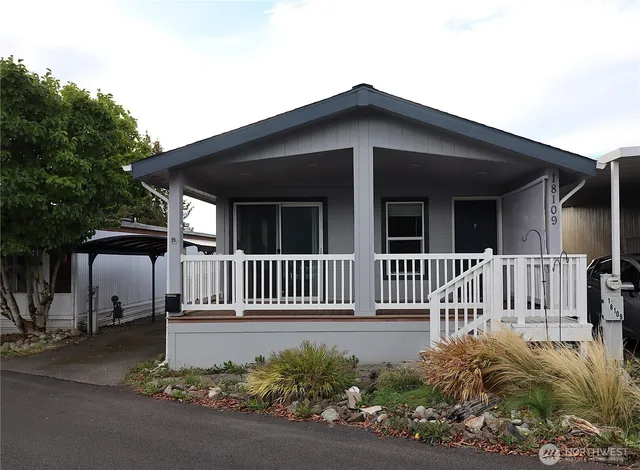 a view of a house with a small yard and plants