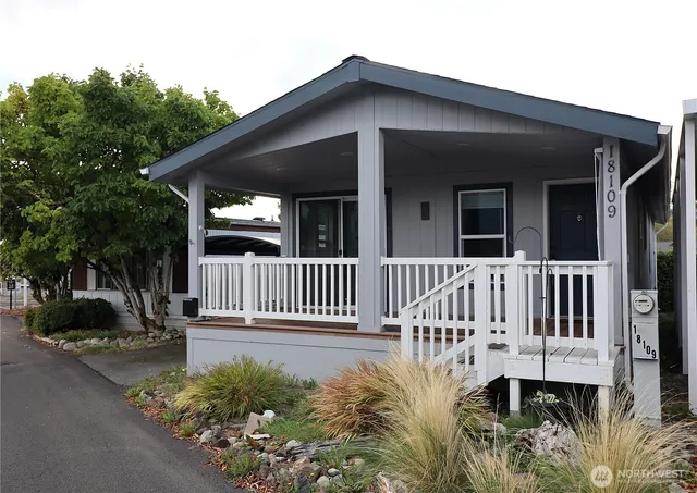 a view of a house with a small yard and a garden