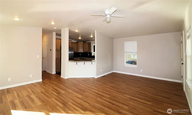 a view of a kitchen with a sink and a refrigerator