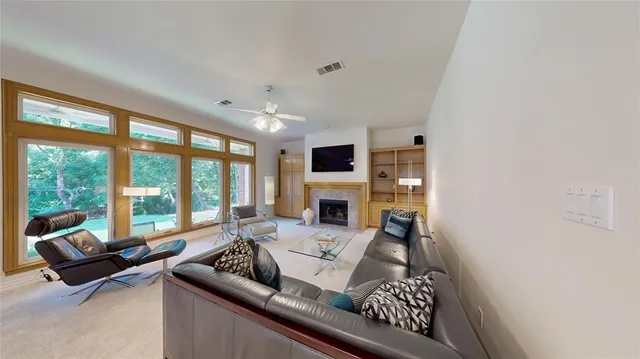 a living room with furniture a fireplace and a flat screen tv
