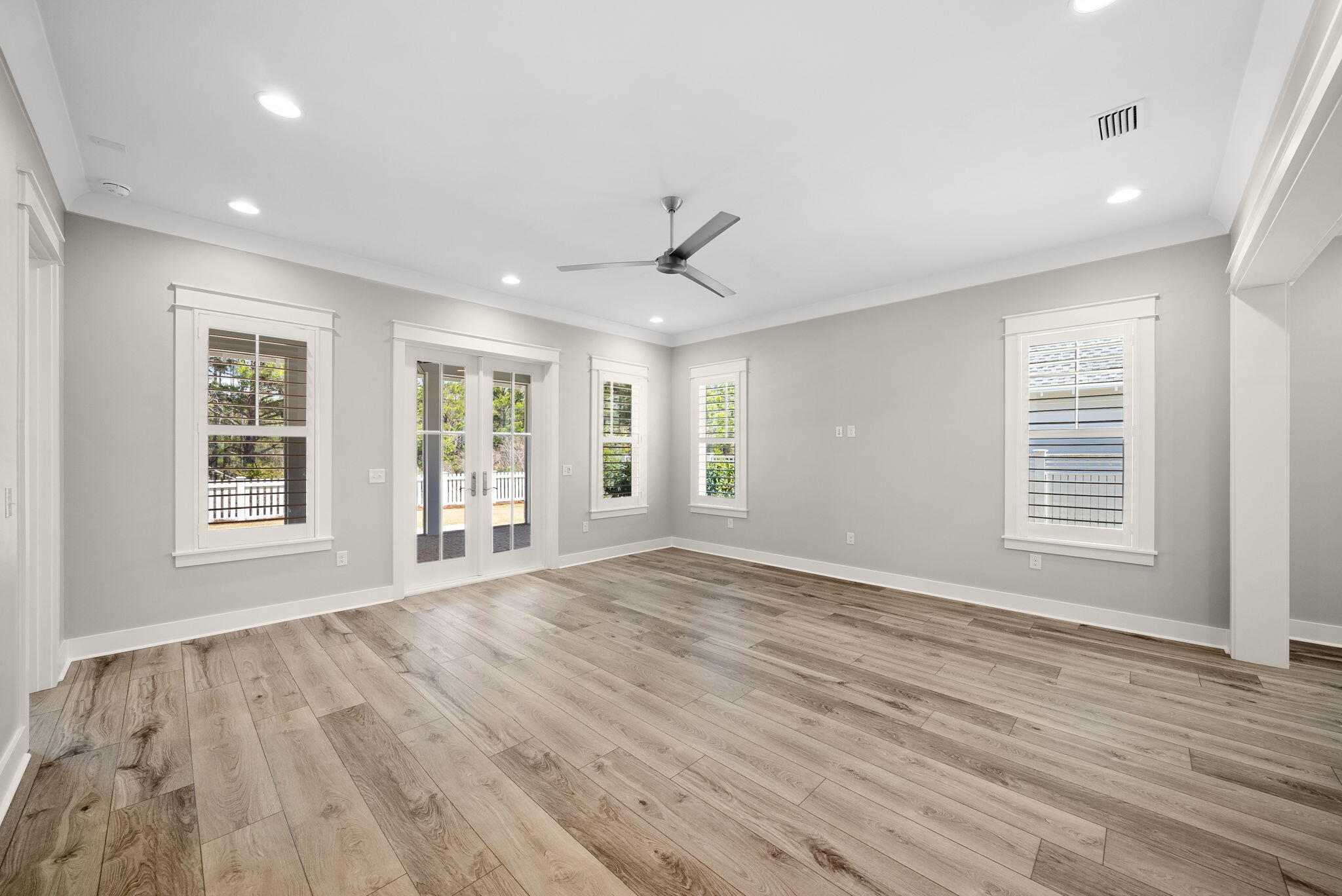 64 West Firethorn Circle Watersound, FL 32461 - Photo 16 of 63 a view of an empty room with wooden floor and a window