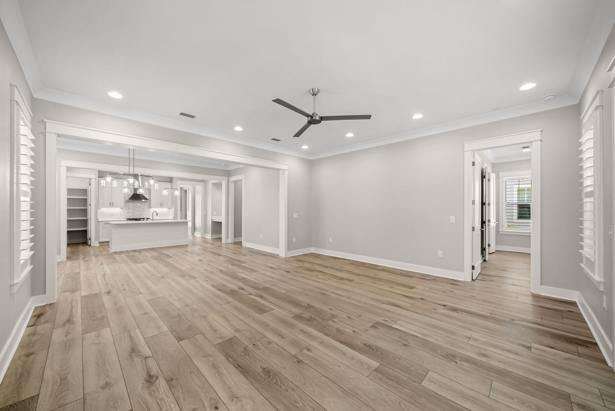 64 West Firethorn Circle Watersound, FL 32461 - Photo 17 of 63 a view of an empty room with wooden floor and a window