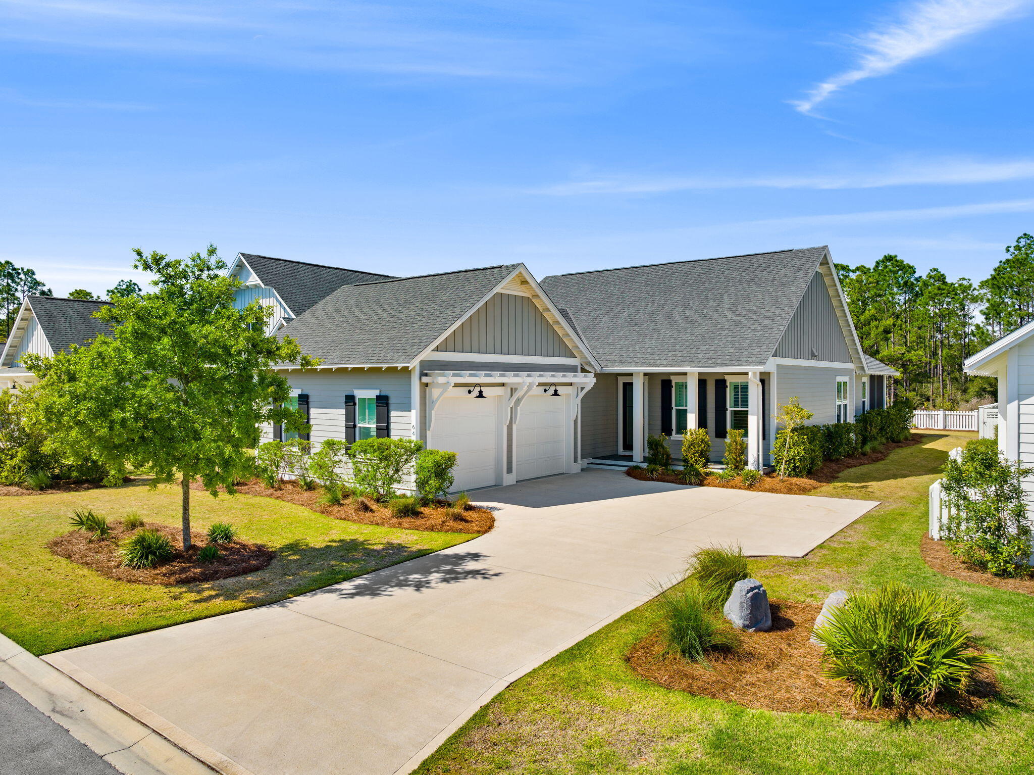 64 West Firethorn Circle Watersound, FL 32461 - Photo 2 of 63 a front view of house with yard and trees in the background