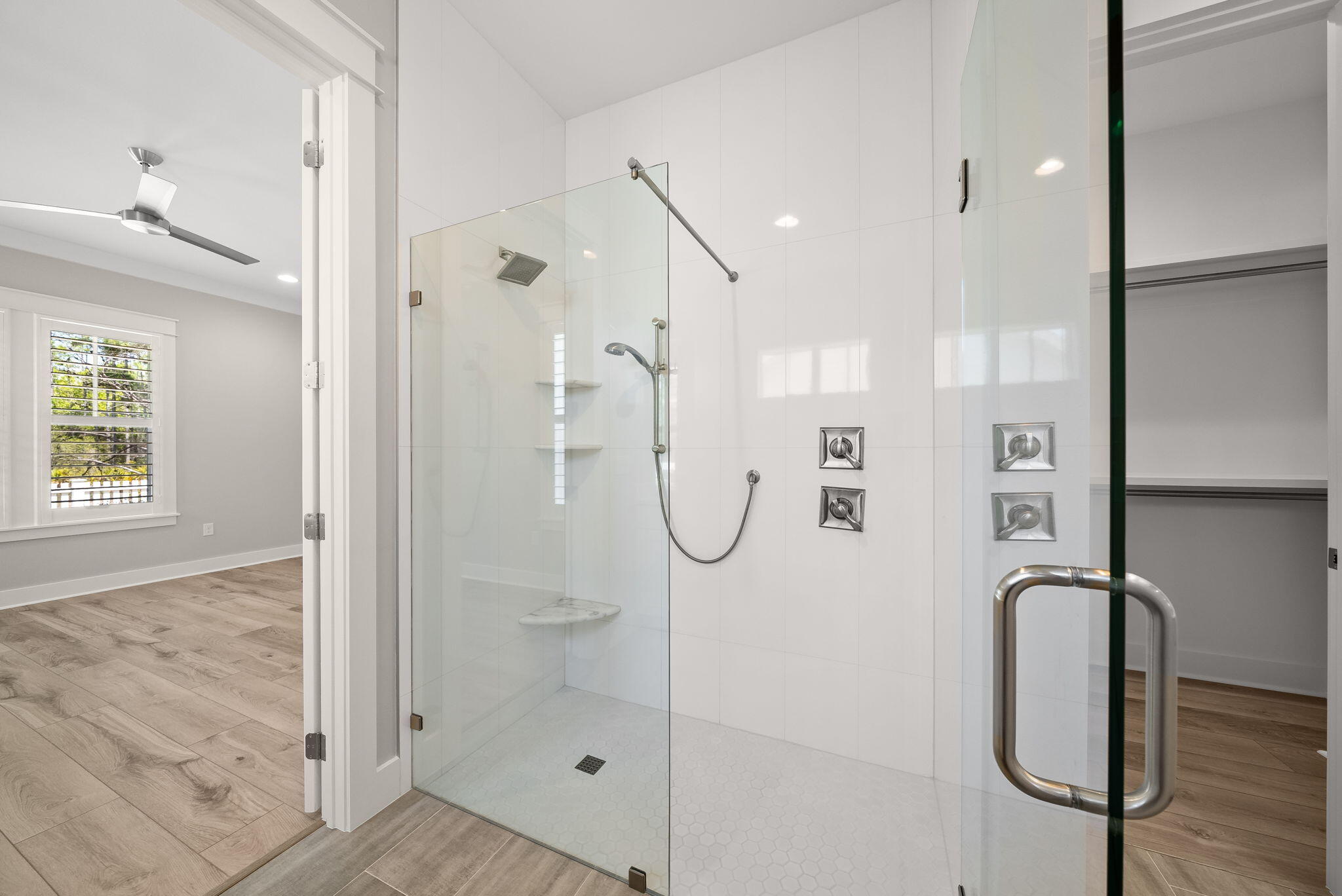 64 West Firethorn Circle Watersound, FL 32461 - Photo 21 of 63 a bathroom with a glass shower door and a mirror