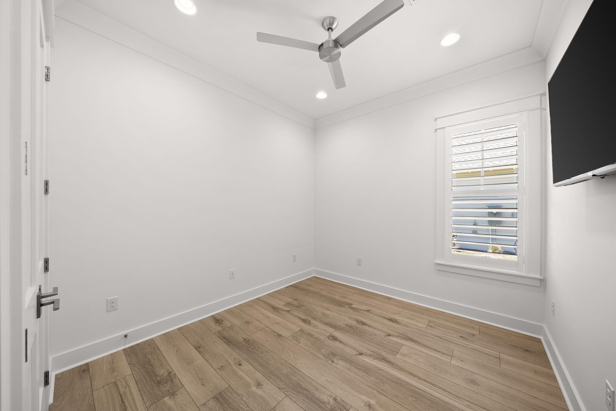 64 West Firethorn Circle Watersound, FL 32461 - Photo 29 of 63 an empty room with a window and wooden floor