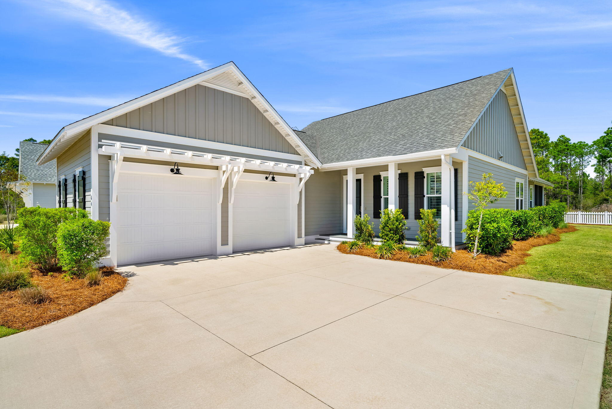64 West Firethorn Circle Watersound, FL 32461 - Photo 4 of 63 a front view of a house with a yard and garage