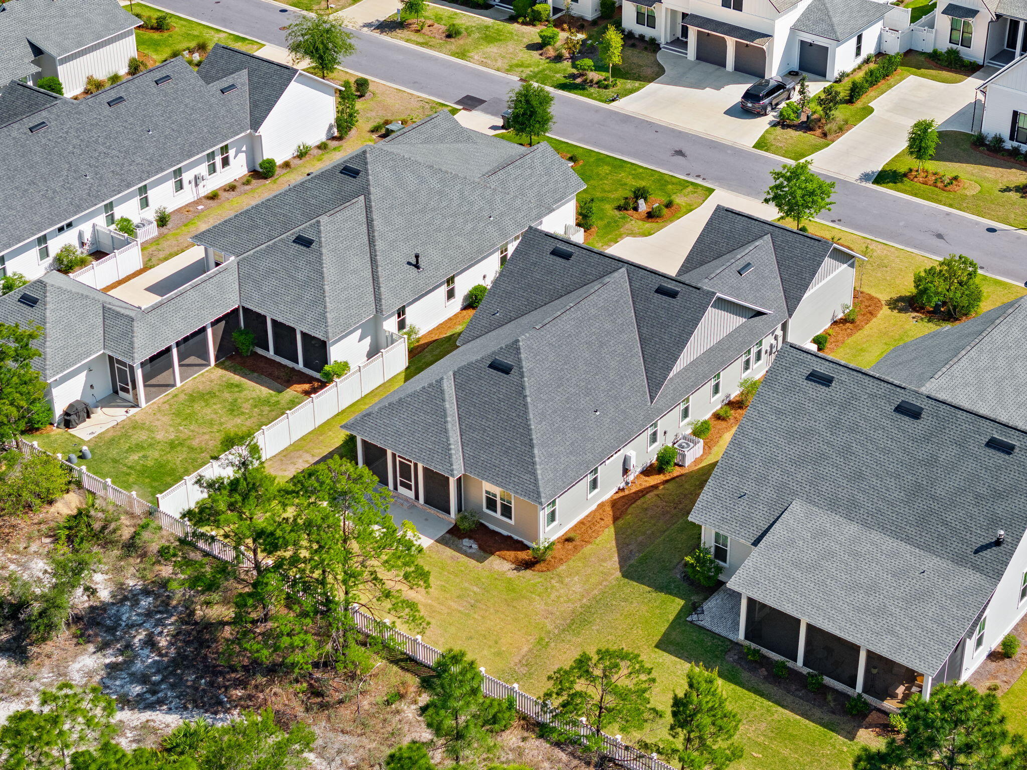 64 West Firethorn Circle Watersound, FL 32461 - Photo 42 of 63 an aerial view of a house with a big yard and large trees