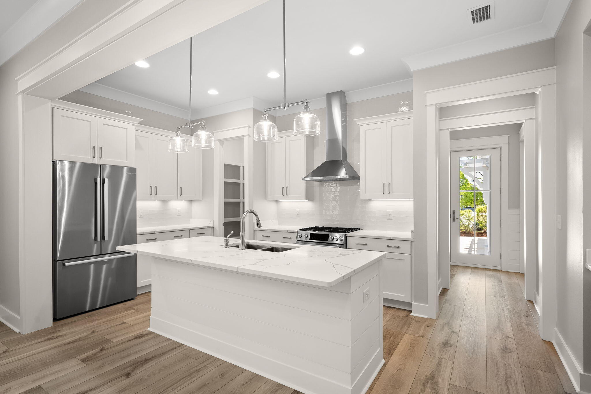 64 West Firethorn Circle Watersound, FL 32461 - Photo 9 of 63 a kitchen with stainless steel appliances a refrigerator a sink dishwasher and a wooden floor