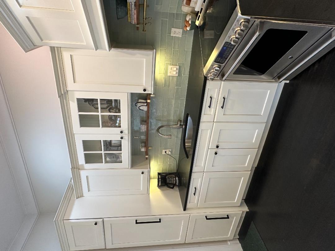 68 Winter Street, Unit 2 Edgartown, MA 02539 - Photo 9 of 19 a kitchen with granite countertop white cabinets and white appliances
