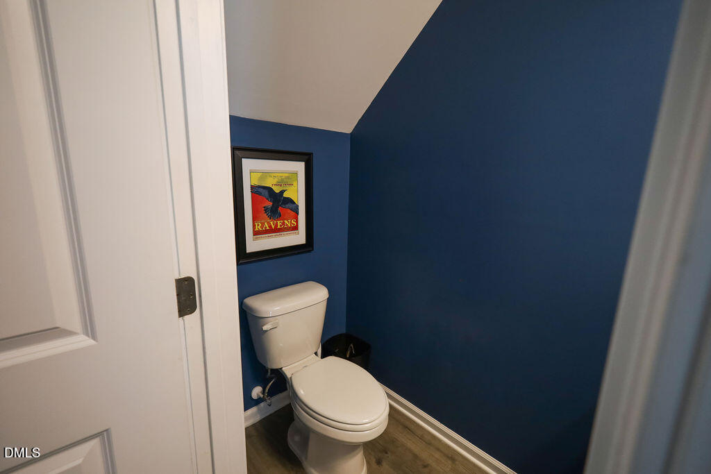 230 South Raleigh Street Angier, NC 27501 - Photo 17 of 38 a white toilet sitting next to a shower curtain