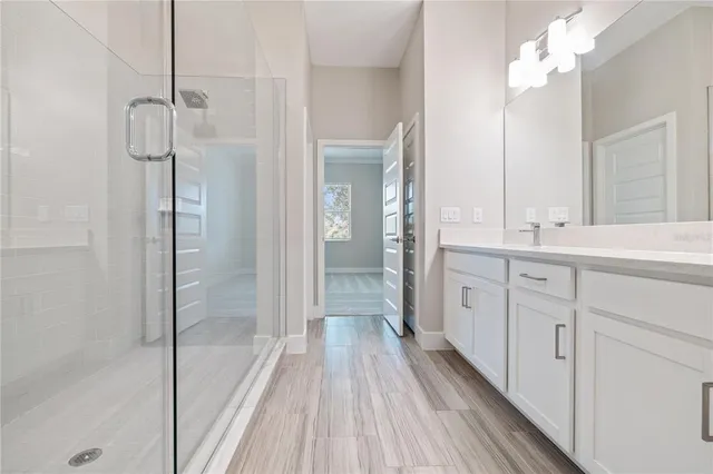 a bathroom with a double vanity sink and mirror