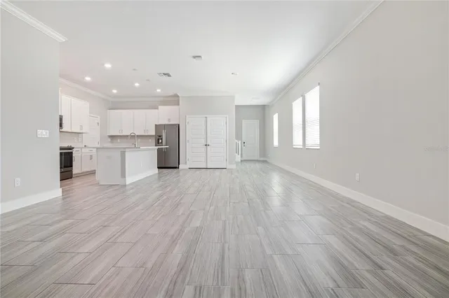 a view of kitchen with refrigerator stove and wooden floor