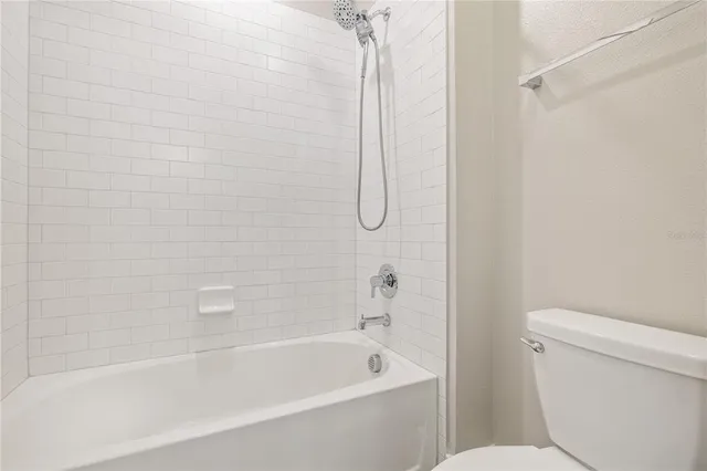 a bathroom with a bathtub and a toilet