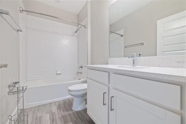 a bathroom with a sink toilet a mirror and shower