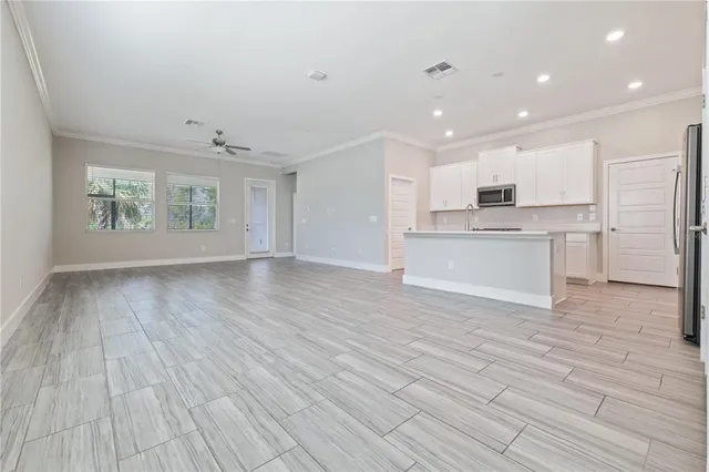 a view of a kitchen with a sink and a refrigerator