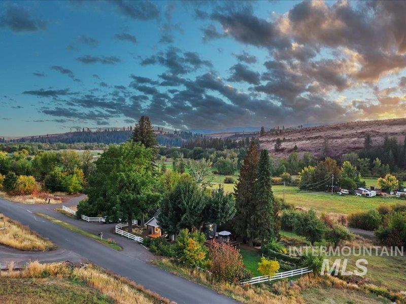 2651 Fruitvale Glendale Road Council, ID 83612 - Photo 5 of 24 Expansive rural property featuring a paved road frontage, white picket fencing, and mature trees