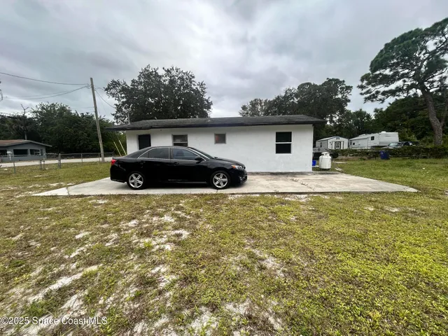 a house view with swimming pool in front of it