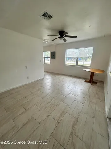 a view of an empty room and a window