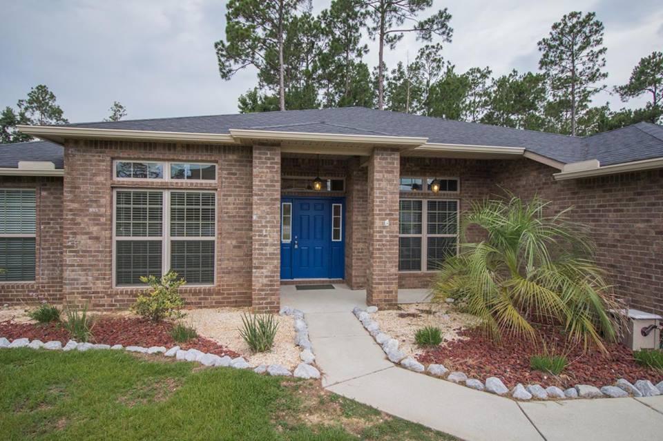 4500 Hermosa Road Crestview, FL 32539 - Photo 1 of 27 a front view of a house with garden