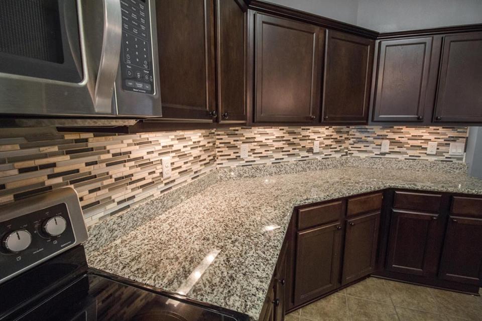 4500 Hermosa Road Crestview, FL 32539 - Photo 12 of 27 a kitchen with granite countertop wooden cabinets and a stove