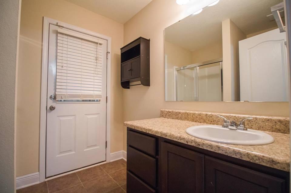 4500 Hermosa Road Crestview, FL 32539 - Photo 17 of 27 a bathroom with a granite countertop sink and mirror