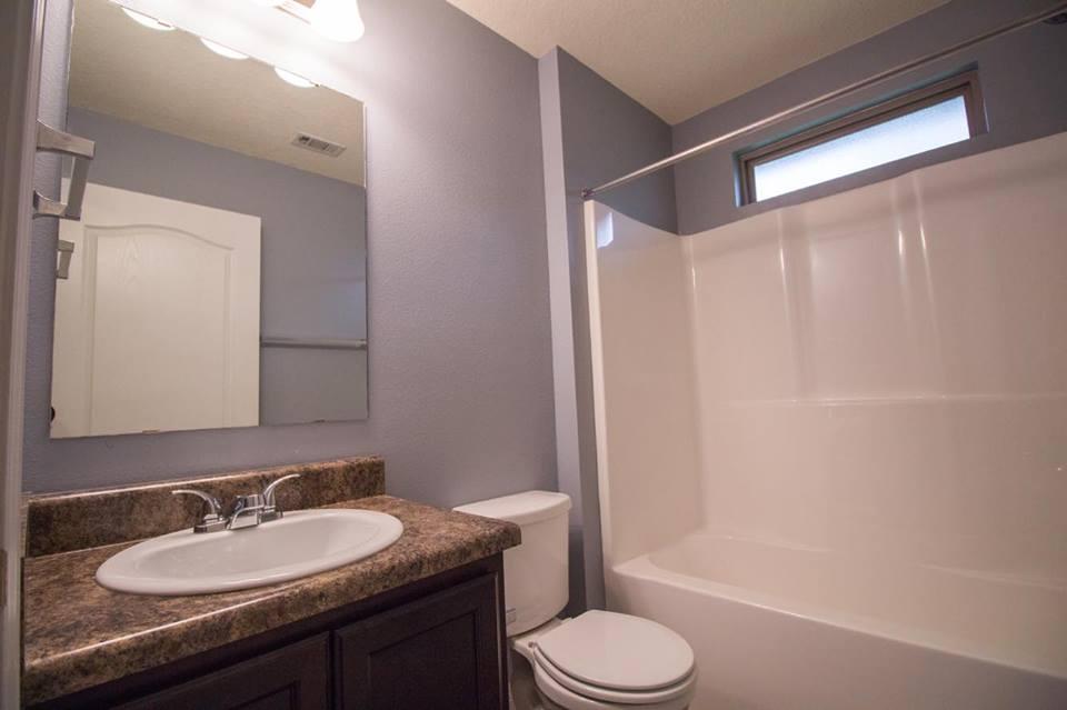 4500 Hermosa Road Crestview, FL 32539 - Photo 18 of 27 a bathroom with a granite countertop sink toilet and shower