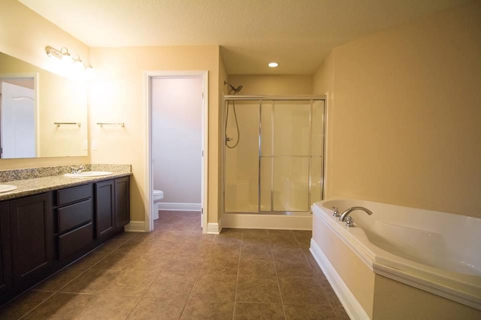 4500 Hermosa Road Crestview, FL 32539 - Photo 20 of 27 a spacious bathroom with a granite countertop tub sink shower and mirror
