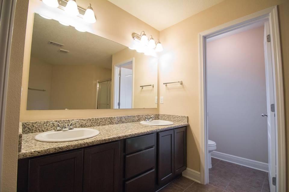 4500 Hermosa Road Crestview, FL 32539 - Photo 21 of 27 a bathroom with a granite countertop sink and a mirror