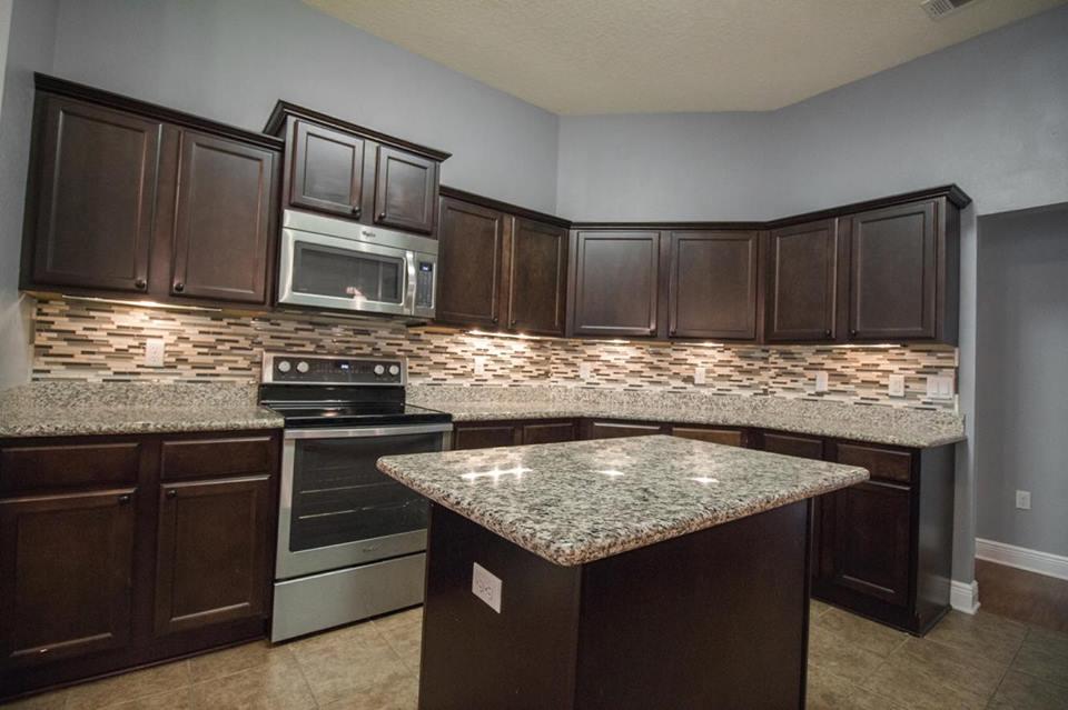 4500 Hermosa Road Crestview, FL 32539 - Photo 9 of 27 a kitchen with granite countertop stainless steel appliances and wooden cabinets