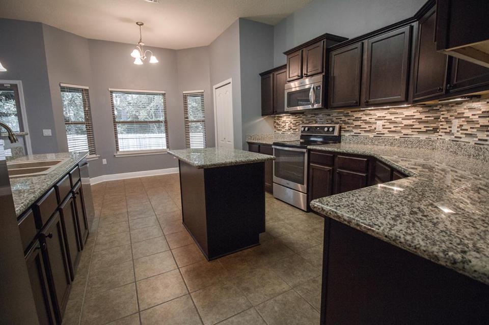 4500 Hermosa Road Crestview, FL 32539 - Photo 10 of 27 a kitchen with stainless steel appliances granite countertop a stove a sink and a microwave