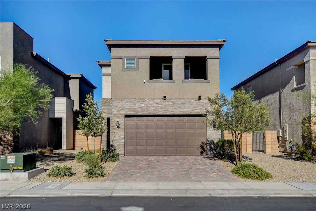 9688 Rankin Rdg Court Las Vegas, NV 89178 - Photo 1 of 53 A modern two-story home with a stone facade and paver driveway invites you to discover its charm.