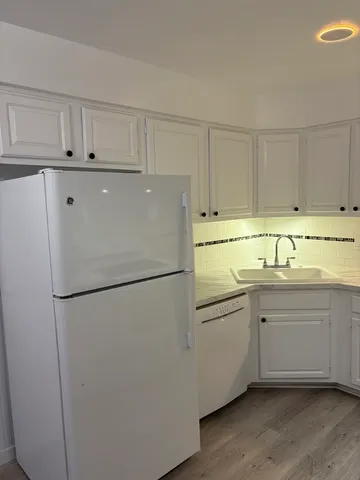 a white toilet sitting next to a bath tub